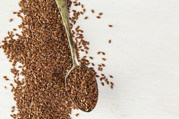 Flax seeds on painted wood board.