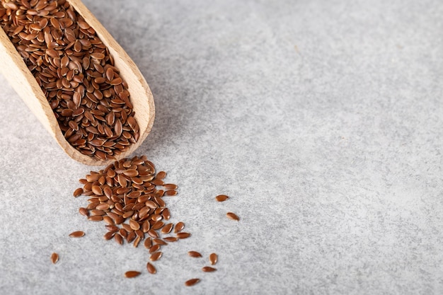 flax seeds in a wooden scoop for bulk products