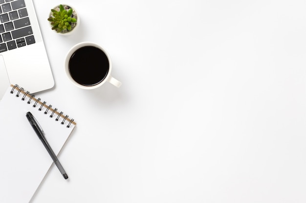 Flay lay, Top view office table desk with keyboard, coffee, pencil, leaves with copy space .