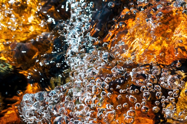 Flecks of sunlight, splash and ripples on the stream water