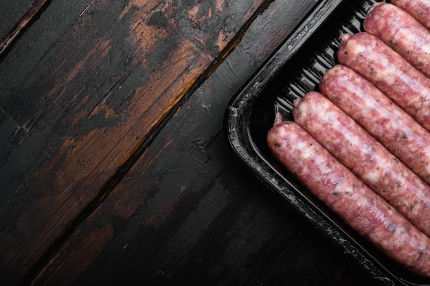 Flesh meat product for cooking packed in box set, on old dark  wooden table background, top view flat lay, with copy space for text