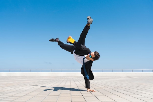 Flexible and cool businessman doing acrobatic trick