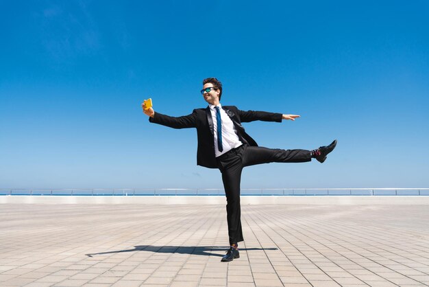 Flexible and cool businessman doing acrobatic trick