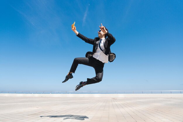 Flexible and cool businessman doing acrobatic trick