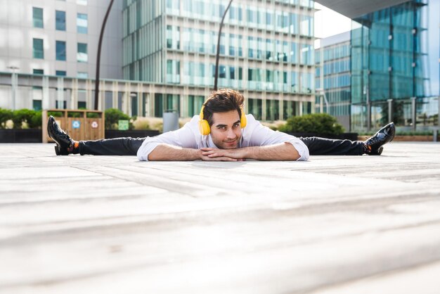 Flexible and cool businessman doing acrobatic trick