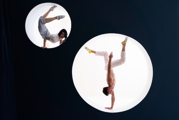 Flexible girl and man doing stretching and handstand in studio concept of individuality creativity and selfconfidence
