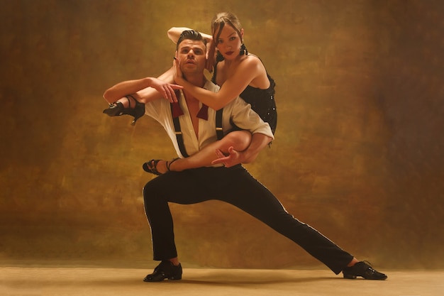 Flexible young modern dance couple posing in studio