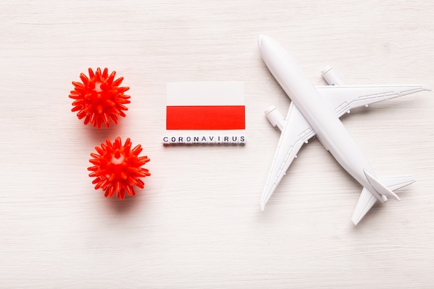 Flight ban and closed borders for tourists and travelers with coronavirus covid-19. Airplane and flag of Poland on a white background. Coronavirus pandemic.