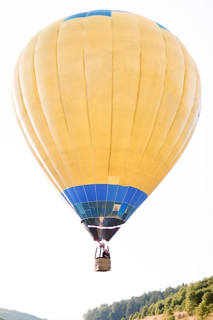 Flight on hot yellow air balloon