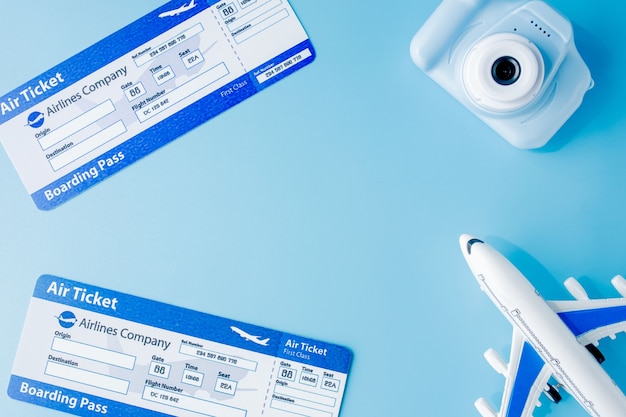 Flight tickets. camera, model of airplane and globe