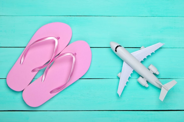 Flip flops, airplane on blue wooden