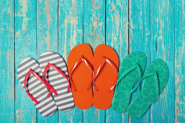 Flip-flops on color wooden background