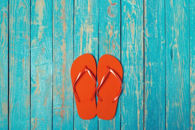 Flipflops on color wooden background