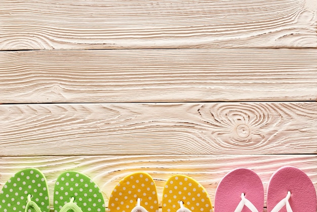 Flipflops over wooden background