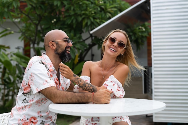 Flirting in a cafe Beautiful loving couple sitting in outdoor cafe and enjoying each other Love romance dating