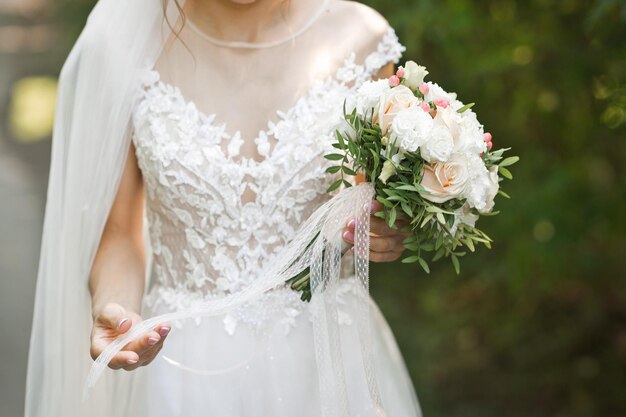 A floating bouquet in the hands of the bride in nature 3198