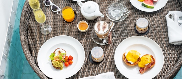 Floating breakfast tray in swimming pool at luxury hotel or tropical resort villa