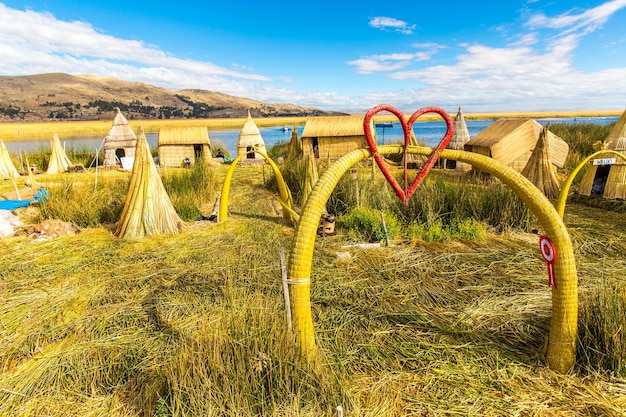 Floating Islands on Lake Titicaca Puno Peru South America thatched home Dense root that plants Khili interweave form natural layer about one to two meters thick that support islands