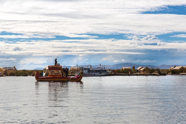 Floating Islands on Lake Titicaca Puno Peru South America thatched home Dense root that plants Khili interweave form natural layer about one to two meters thick that support islands