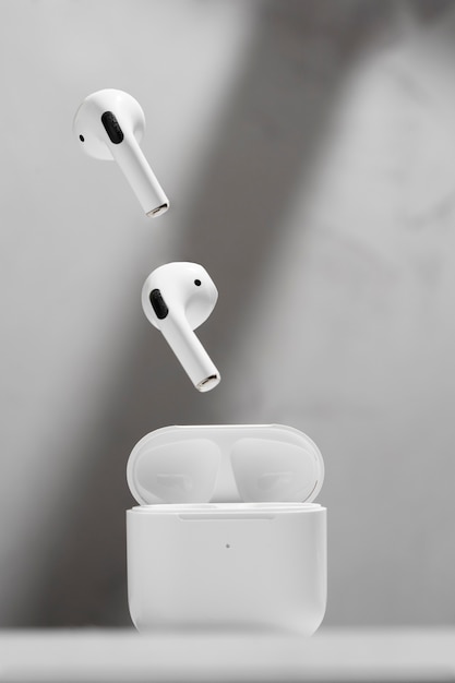 Floating modern wireless earphones with concrete background