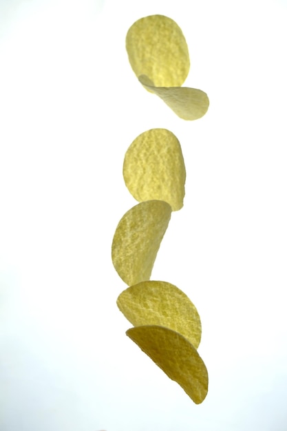 floating potato chips in the studio on a white background