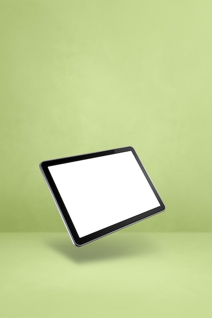 Floating tablet pc computer isolated on green Vertical background