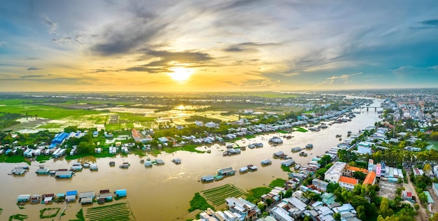 Floating village along hau river at dawn in the sky over\
vietnam border area, aerial view.