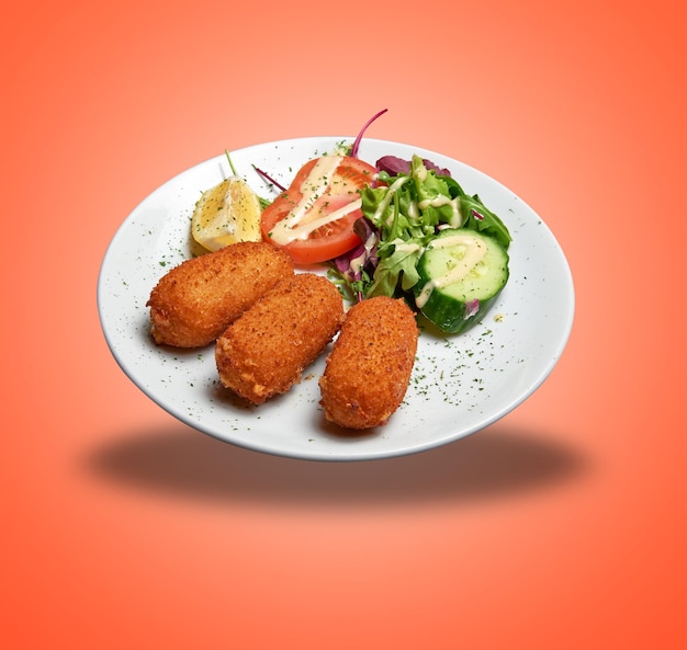 Floating White plate with three Shrimps croquettes ans salad