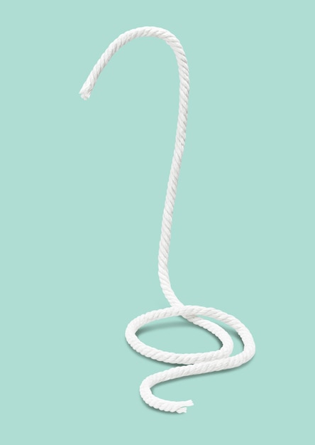 Photo floating white rope isolated on green background