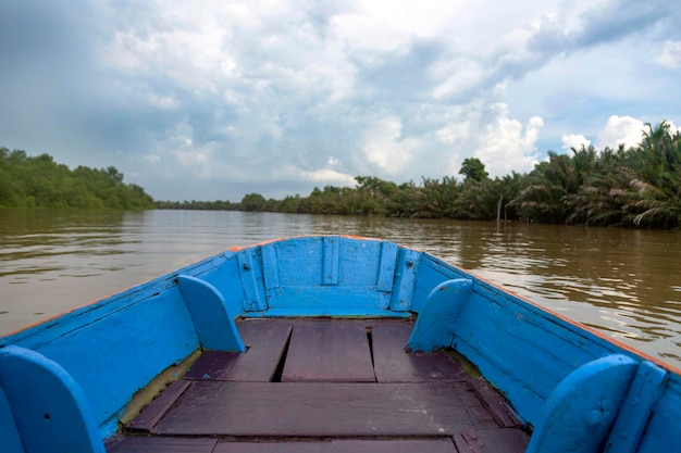 Floating wood boat on river landscape