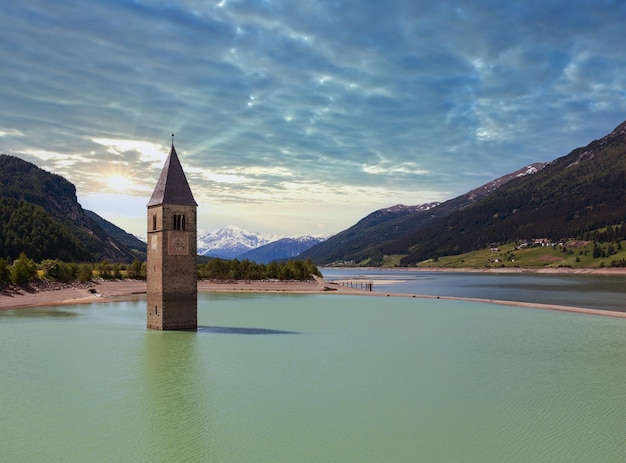 Photo flooded in 1950 bell tower in reschensee and family italy church building in 14thcentury