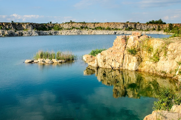 Flooded industrial granite career with waterfalls