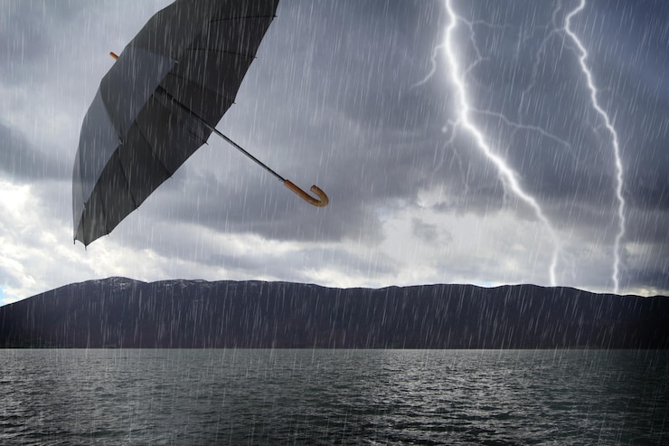 फोटो flooded stormy landscape and flying umbrella in the air