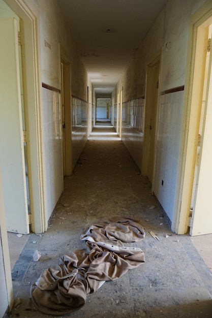 The floor of the old building is covered in debris.