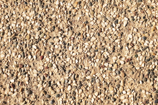 A floor of small sea pebbles on the sand as a background