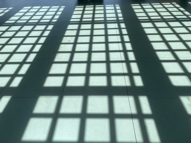 A floor with a grid of windows and a grid of bars.