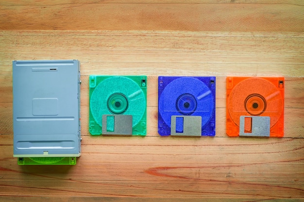 Floppy disk drive and diskettes on wooden table