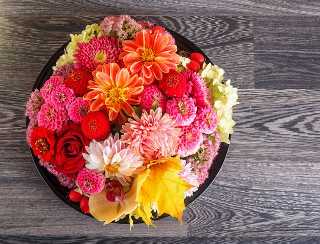 Floral arrangement of autumn flowers on a plate