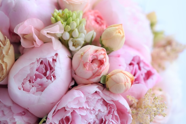 Floral arrangement of fresh pink peonies, astilba, rose and carnation