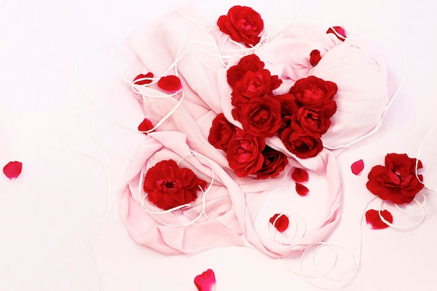 Floral arrangement of red roses on a light background.