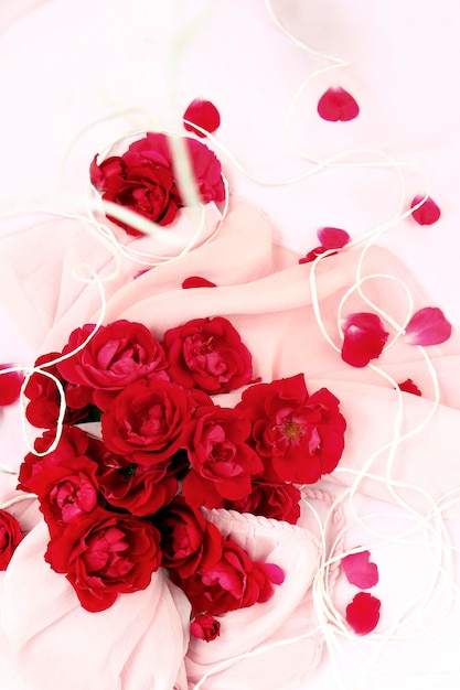 Floral arrangement of red roses on a light background.