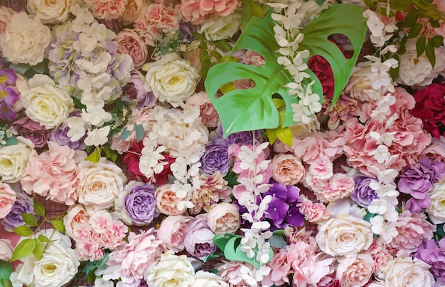 Floral background lot of artificial flowers in colorful composition on handmade wooden pink