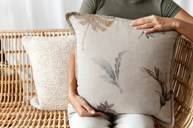 Photo floral beige cushion held by a woman interior design