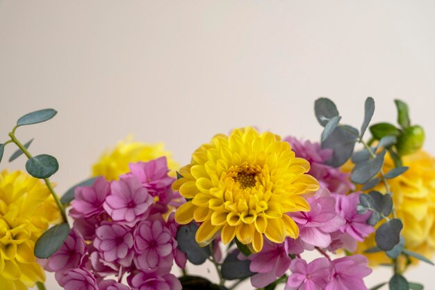 Floral composition greeting card mock up Pink and yellow flowers with copy space Hydrangea dahlias and eucalyptus