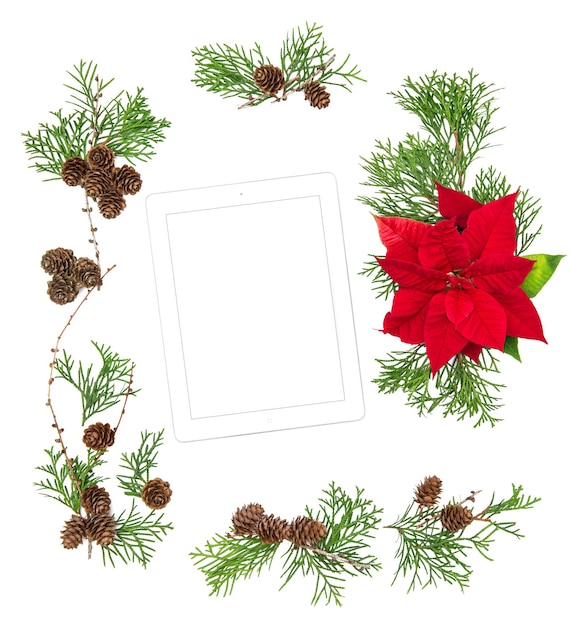 Floral Flat lay background Mock up tablet pc. Red Christmas flower and pine cones decoration