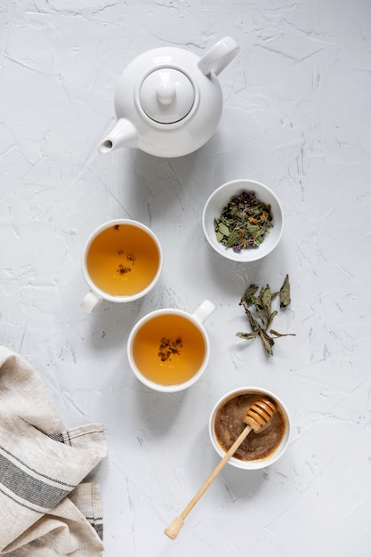 Floral green tea on table with tea kettle and napkin