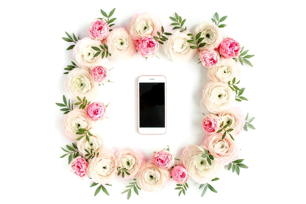 Floral pattern frame made of pink ranunculus and roses flower
buds on white background flat lay top