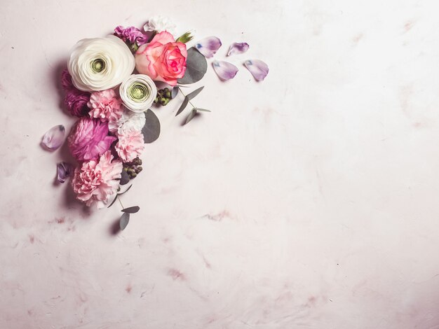 Floral round frame with eucalyptus branches and leaves, flat lay flowers, top view with copy space