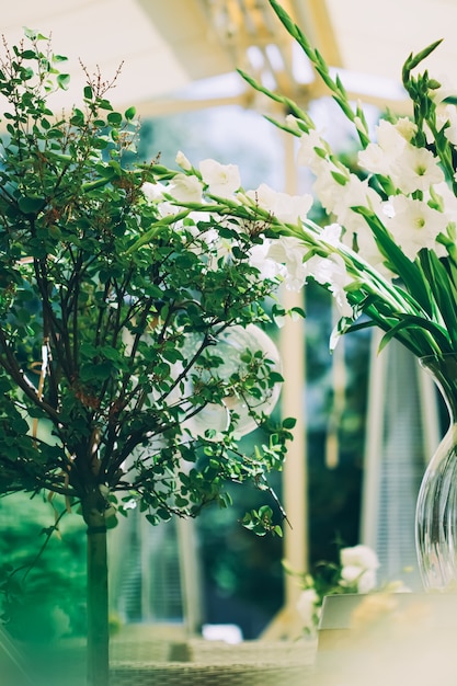 Floral wedding decoration in a restaurant outdoors in summer