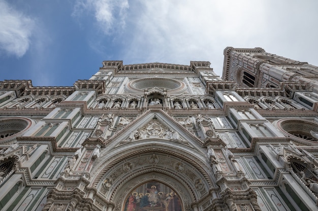 Florence, Italy - June 24, 2018: Closeup view of facade of Cattedrale di Santa Maria del Fiore (Cathedral of Saint Mary of the Flower) is the cathedral of Florence